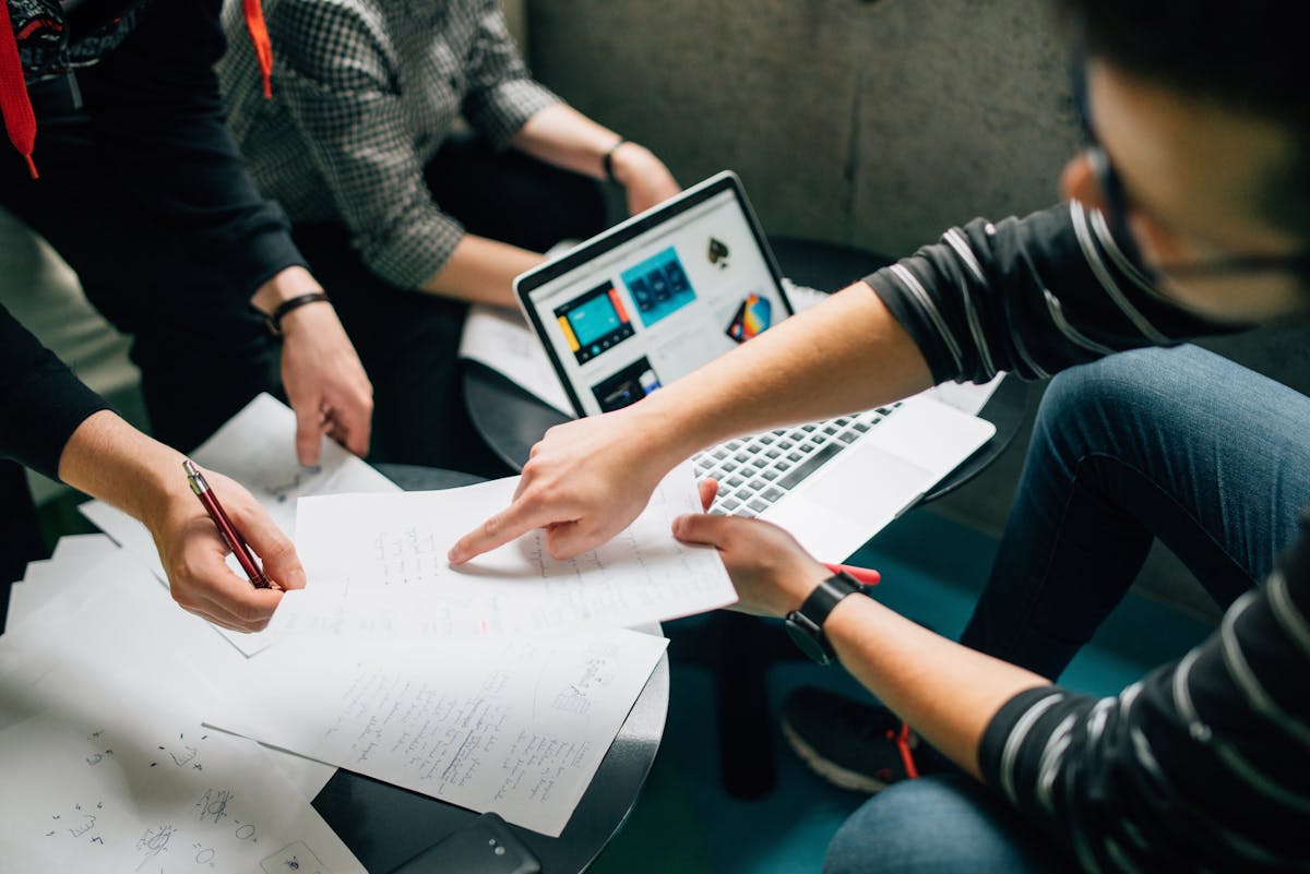 people meeting and discussing papers