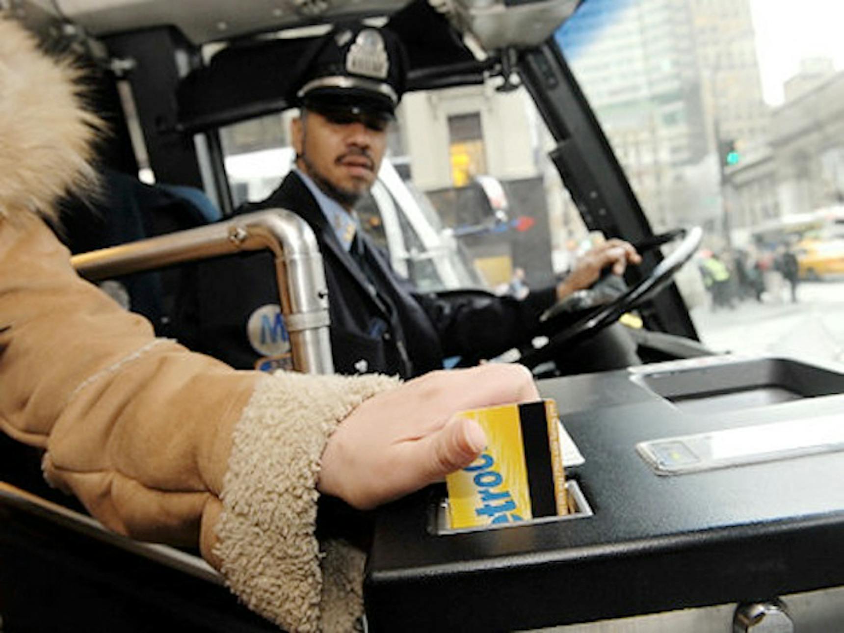 swiping metro card at bus stop