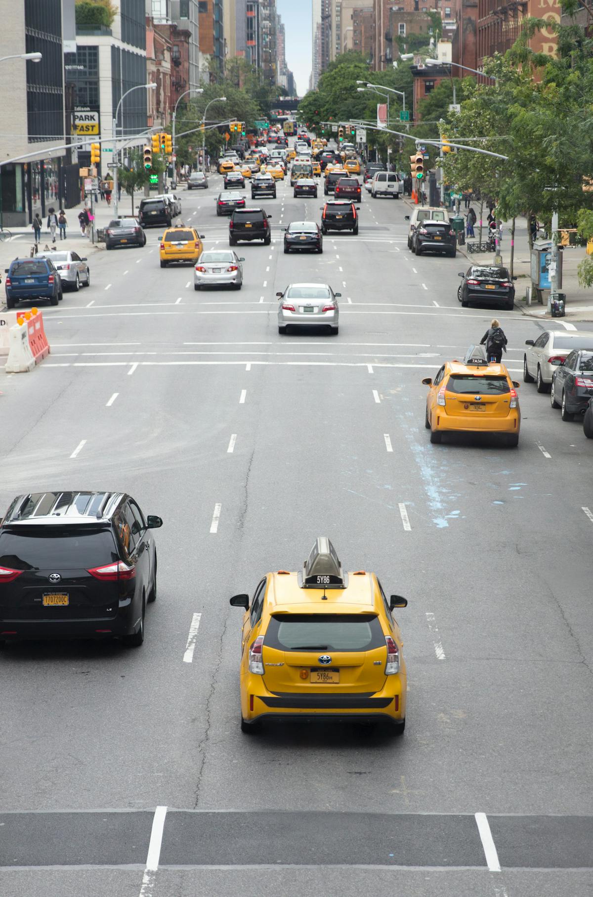 taxis driving down an avenue