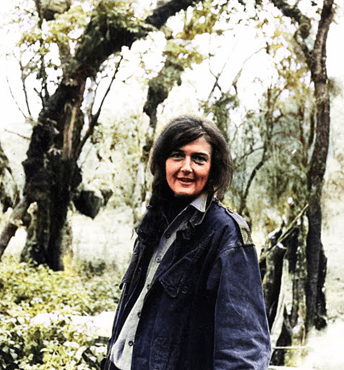 Dian Fossey posting in front of trees. Image credit: Courtesy of Dian Fossey Gorilla Fund