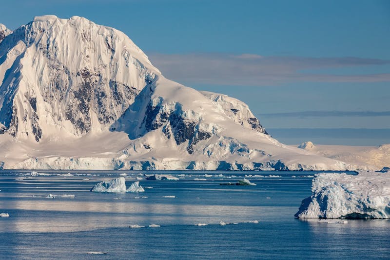Mountain scenery on Cuverville Island in the Errera Channel of the west coast of the Antarctic Peninsula in Antarctica. Image Credit: By SteveAllenPhoto999, Envato Elements.