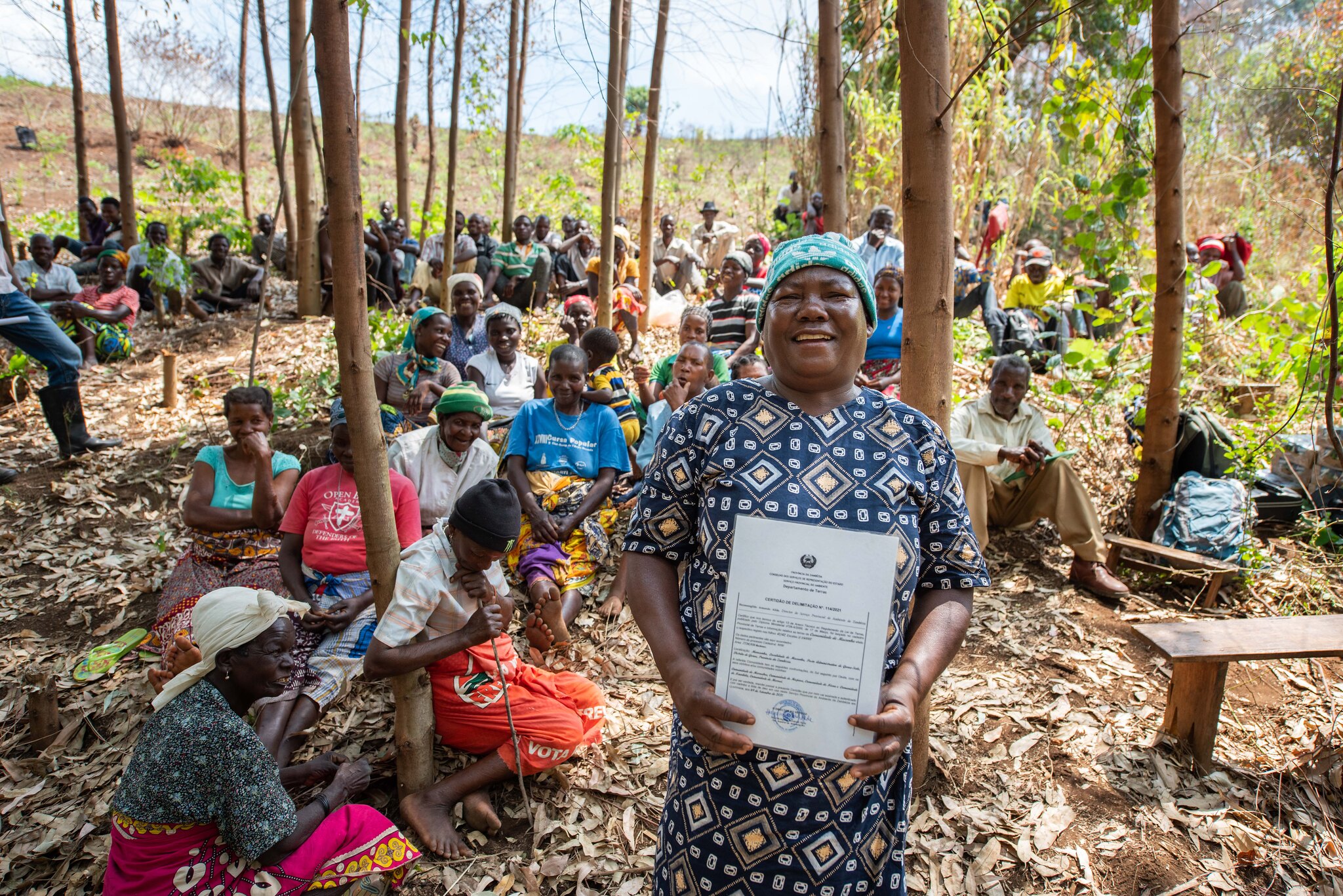 Queen Adelina of Mucunha holding the legal deed that recognizes the ownership of Namuli’s land by the Lomwe people. This is a historical achievement in a region with a legacy of colonial occupation and displacement of community in favor of external enterprises. As part of the process of land delimitation, 70% of the household lands have been titled to women reinforcing their central role in Lomwe culture and politics. Photo by Roshni Lodhia/Legado