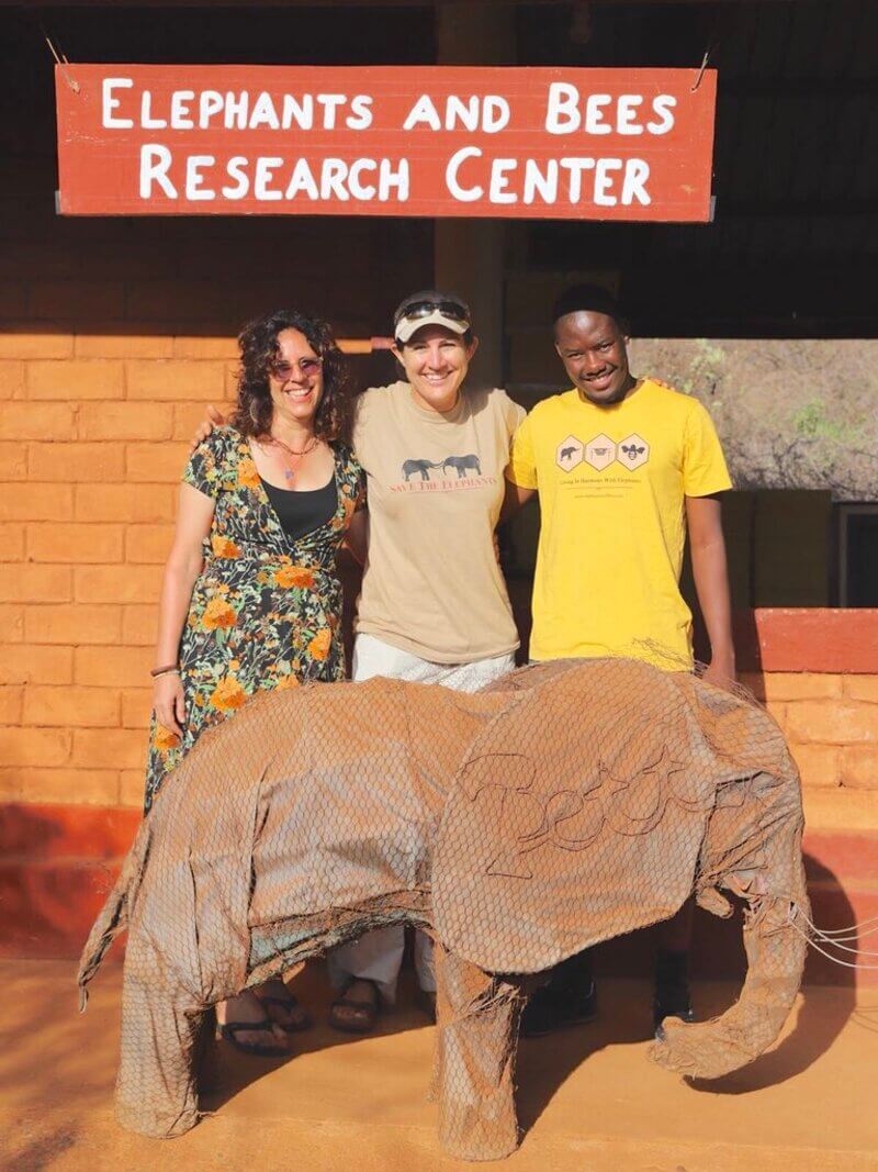 Dr. Kucy King with guests in front of the Elephants and Bees Research Center.