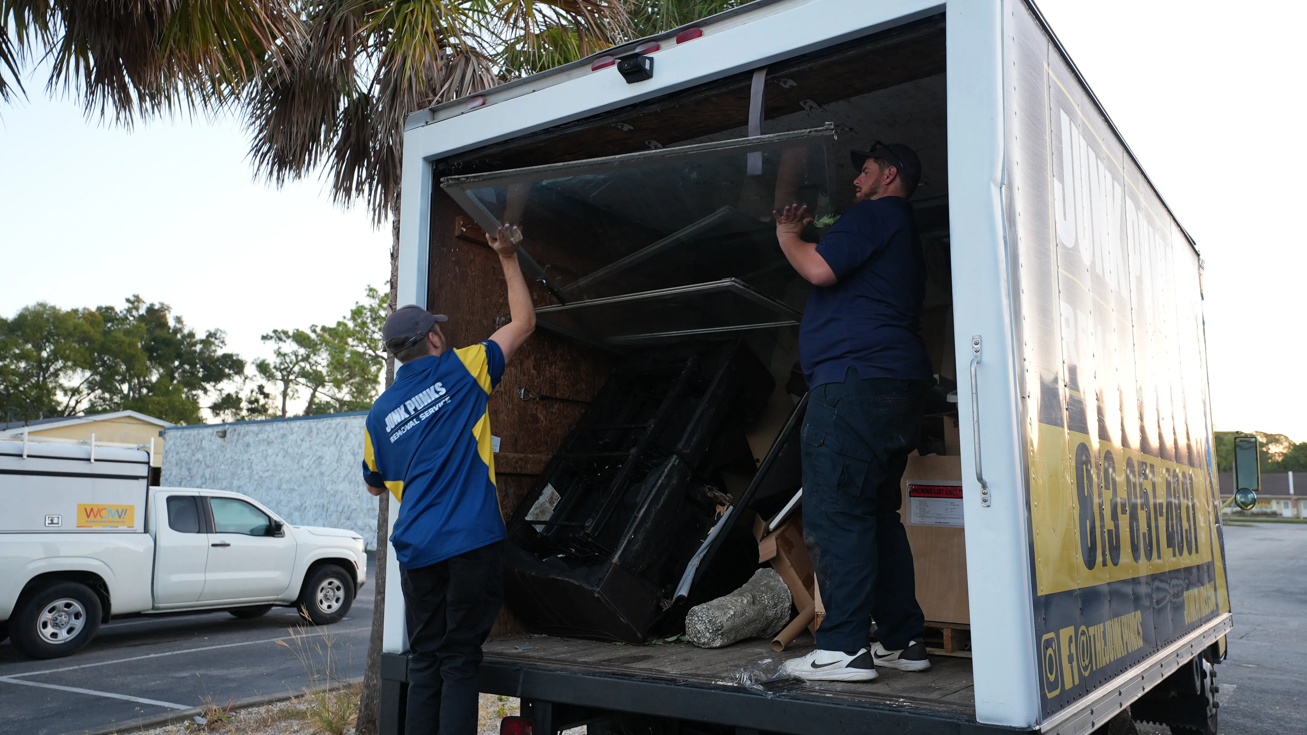 A Junk Punks crew loads material during a removal job. Items in a single load can require different decisions about reuse, recycling, or disposal. Image Credit: Courtesy of Junk Punks. A Junk Punks crew loads material during a removal job. Items in a single load can require different decisions about reuse, recycling, or disposal. Image Credit: Courtesy of Junk Punks.