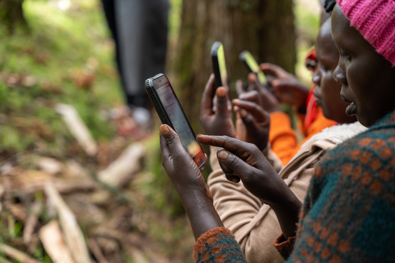 Ogiek women mapping out land using Mapeo. Image credit: Courtesy of Digital Democracy