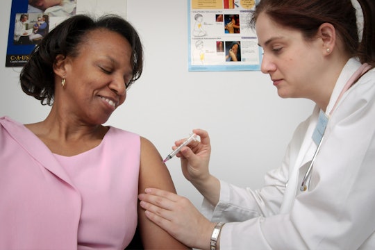 A patient receives a shot from their doctor