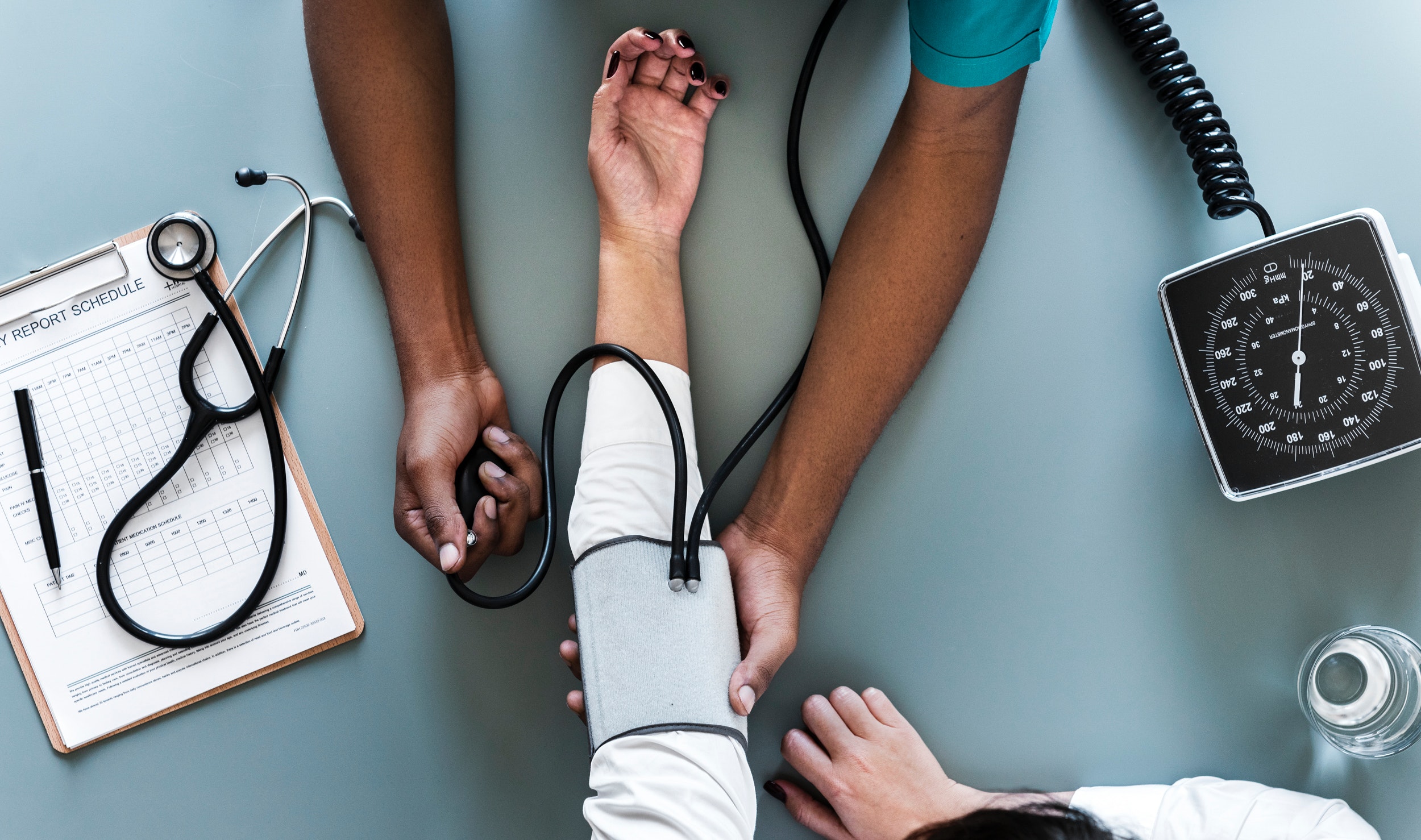 doctors taking blood pressure