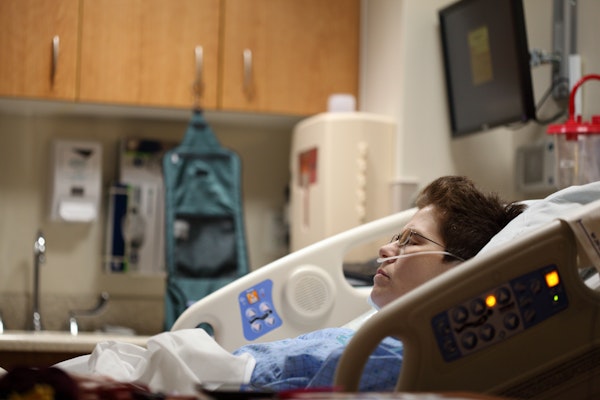 A patient sleeping in a hospital bed A patient sleeping in a hospital bed
