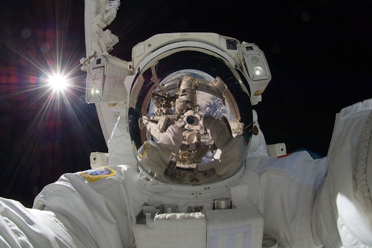 Japan Aerospace Exploration Agency astronaut Aki Hoshide takes a space selfie during an extravehicular activity (EVA).