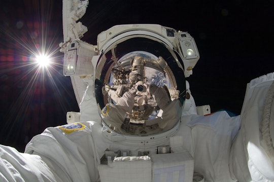 Japan Aerospace Exploration Agency astronaut Aki Hoshide takes a space selfie during an extravehicular activity (EVA). 