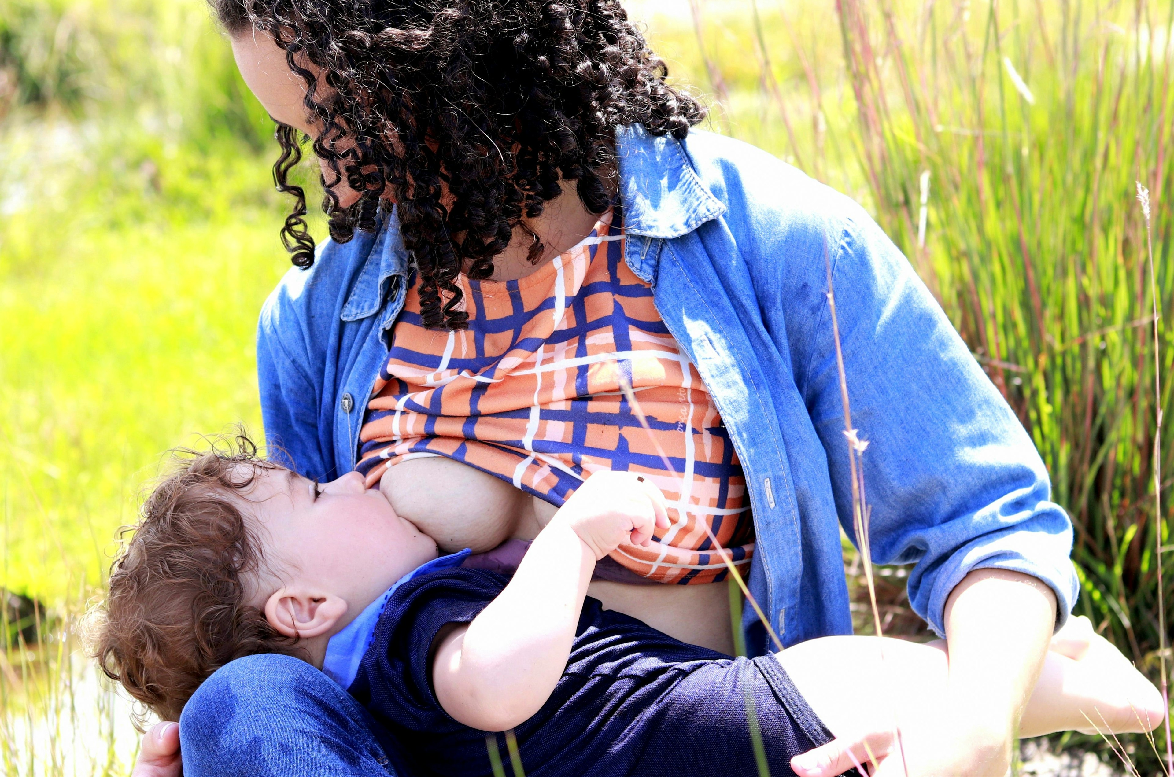 A child breastfeeding/chestfeeding