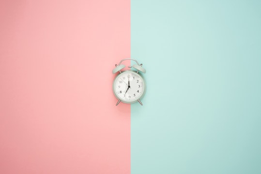 alarm clock on a pink and blue background
