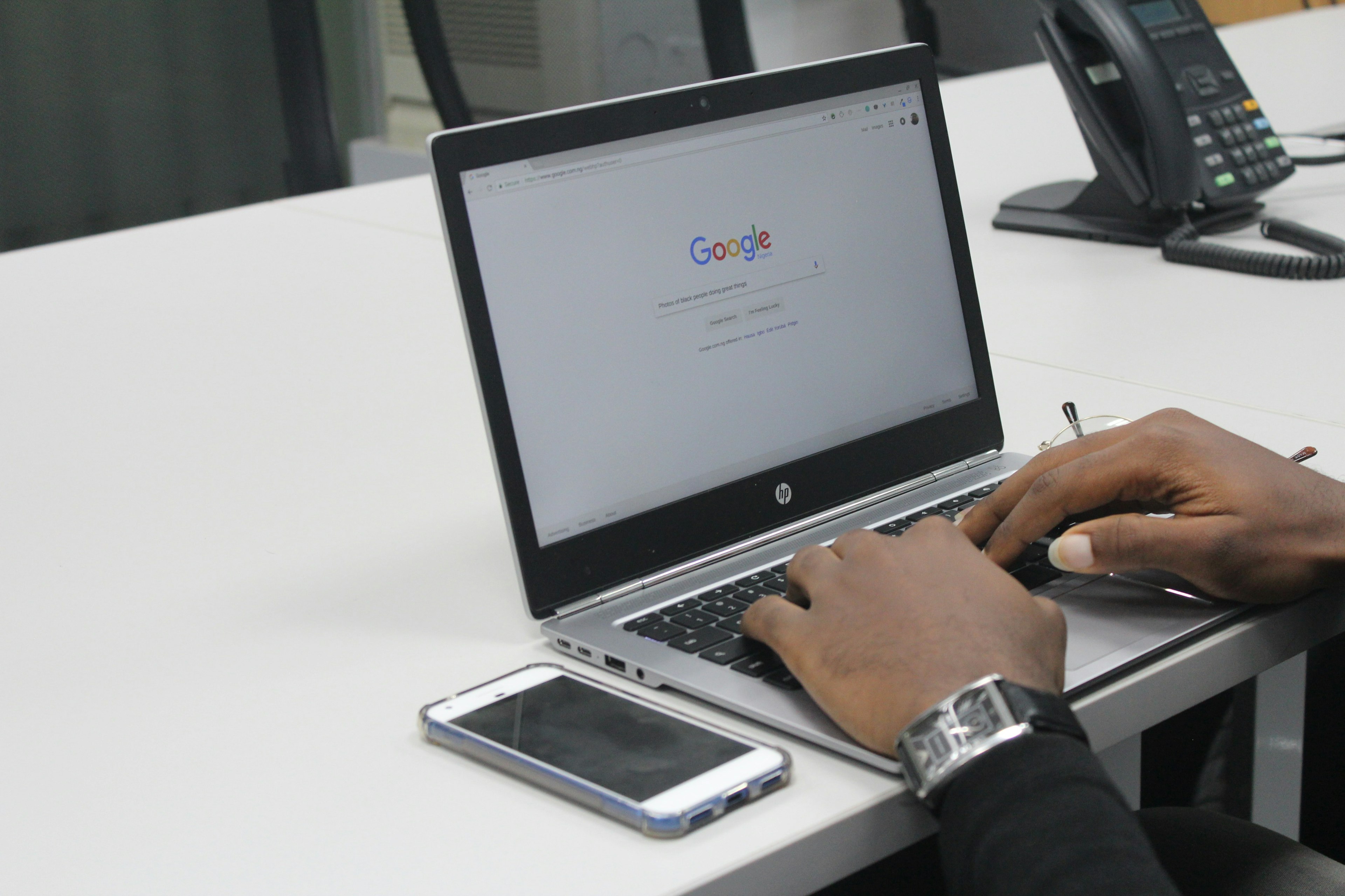 a person typing on a computer with Google on the screen