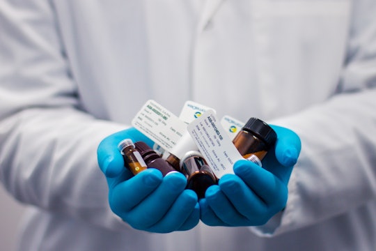 White coat with gloves holding drugs White coat with gloves holding drugs