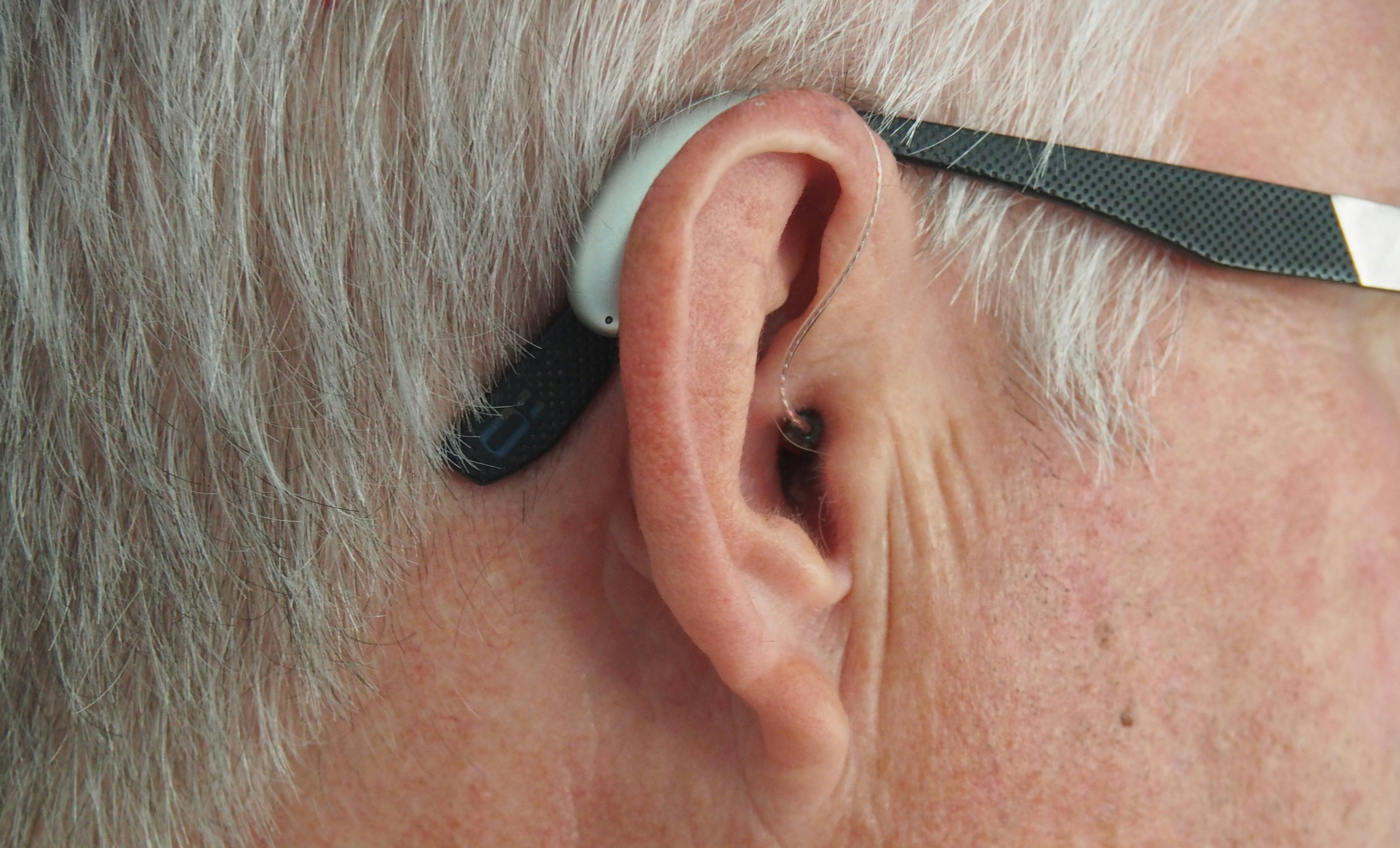 close up of ear of a person wearing a hearing aid