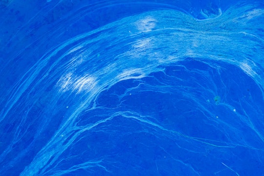 abstract picture of light blue strands against dark blue that looks like rushing water