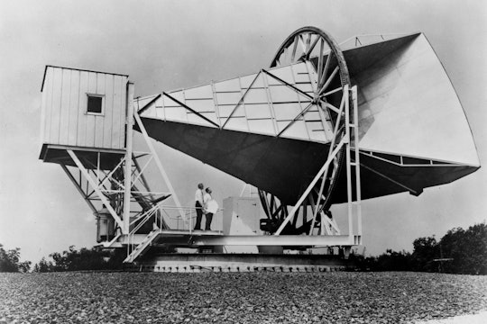 black and white photo of an old telescope