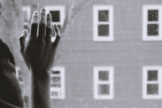 lonely person hand on window person looking outside