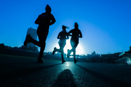 silhouettes of three women running
