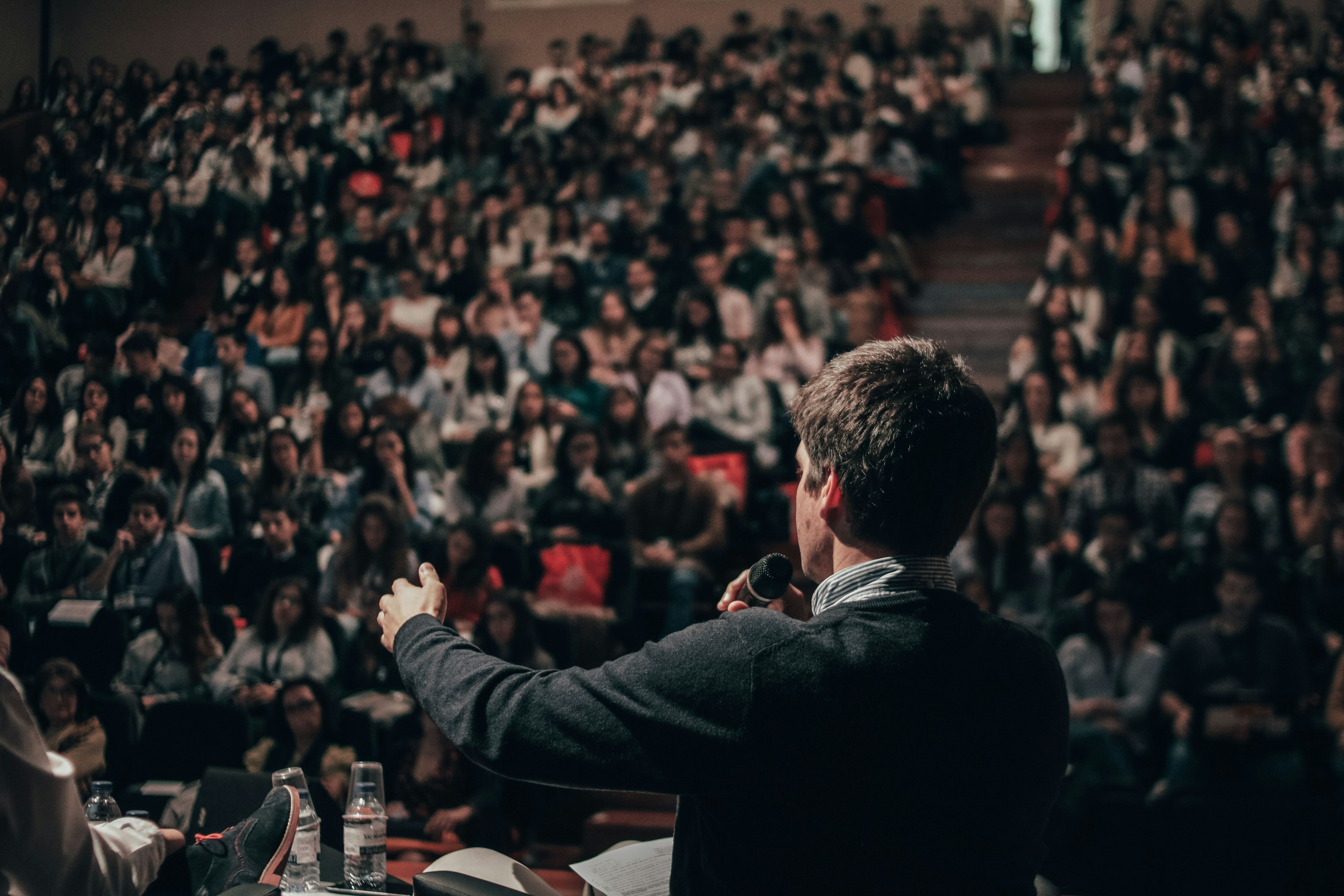 A person giving a speech in front of a conference