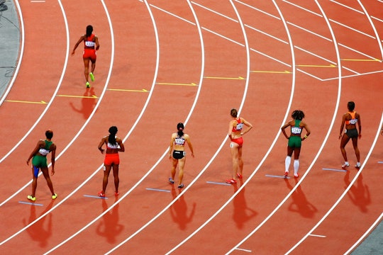 A photo of sprinters on a track waiting at the starting line.