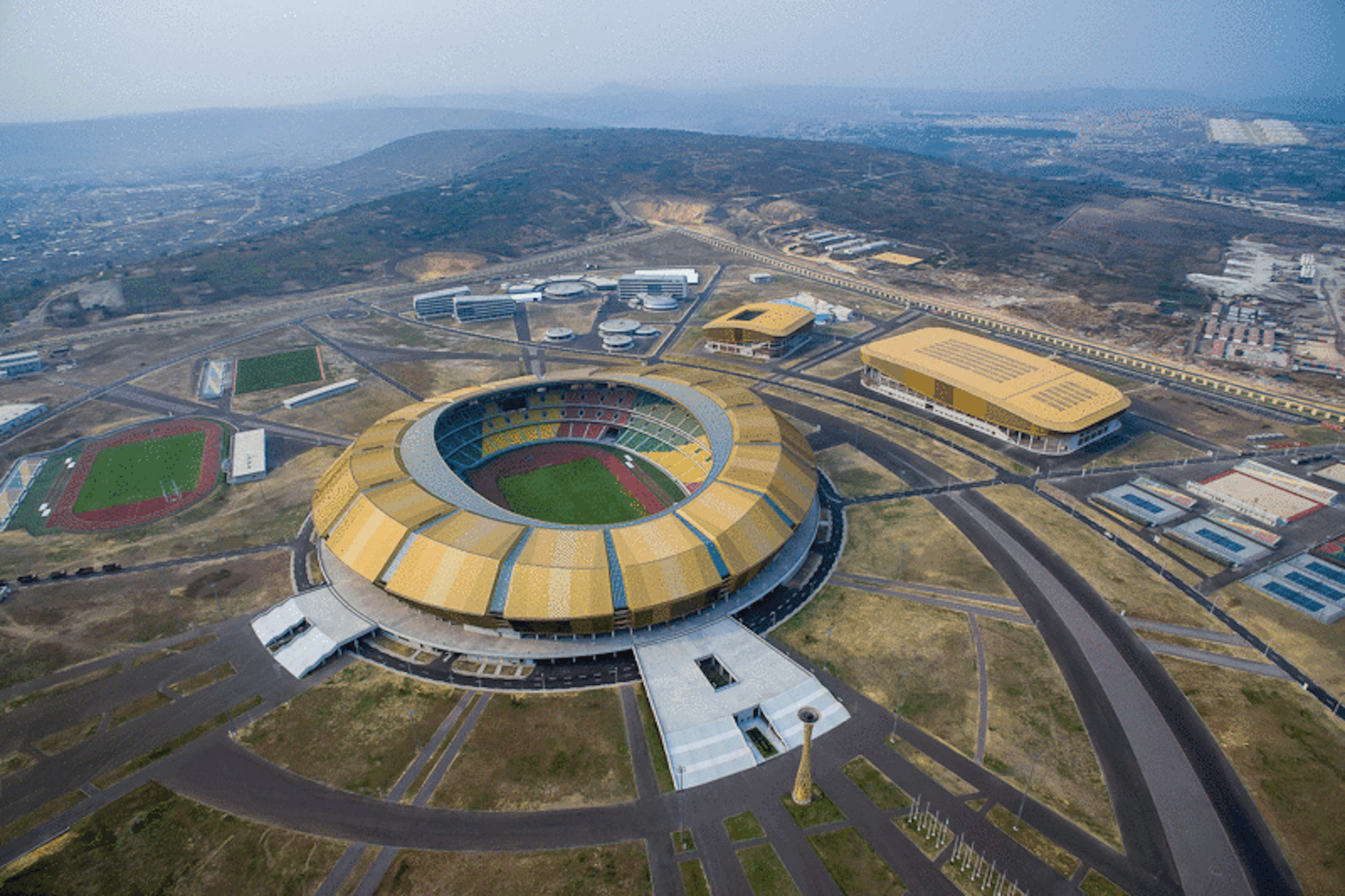 overview of part of the city of brazzaville with a sports stadium in the foreground