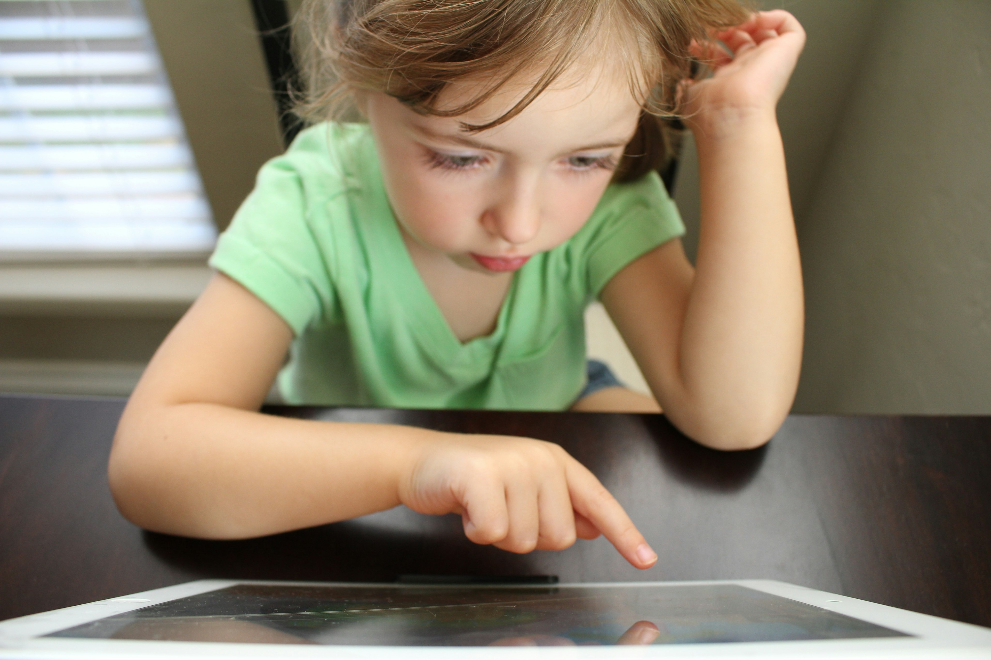 A child uses a touch screen tablet computer.