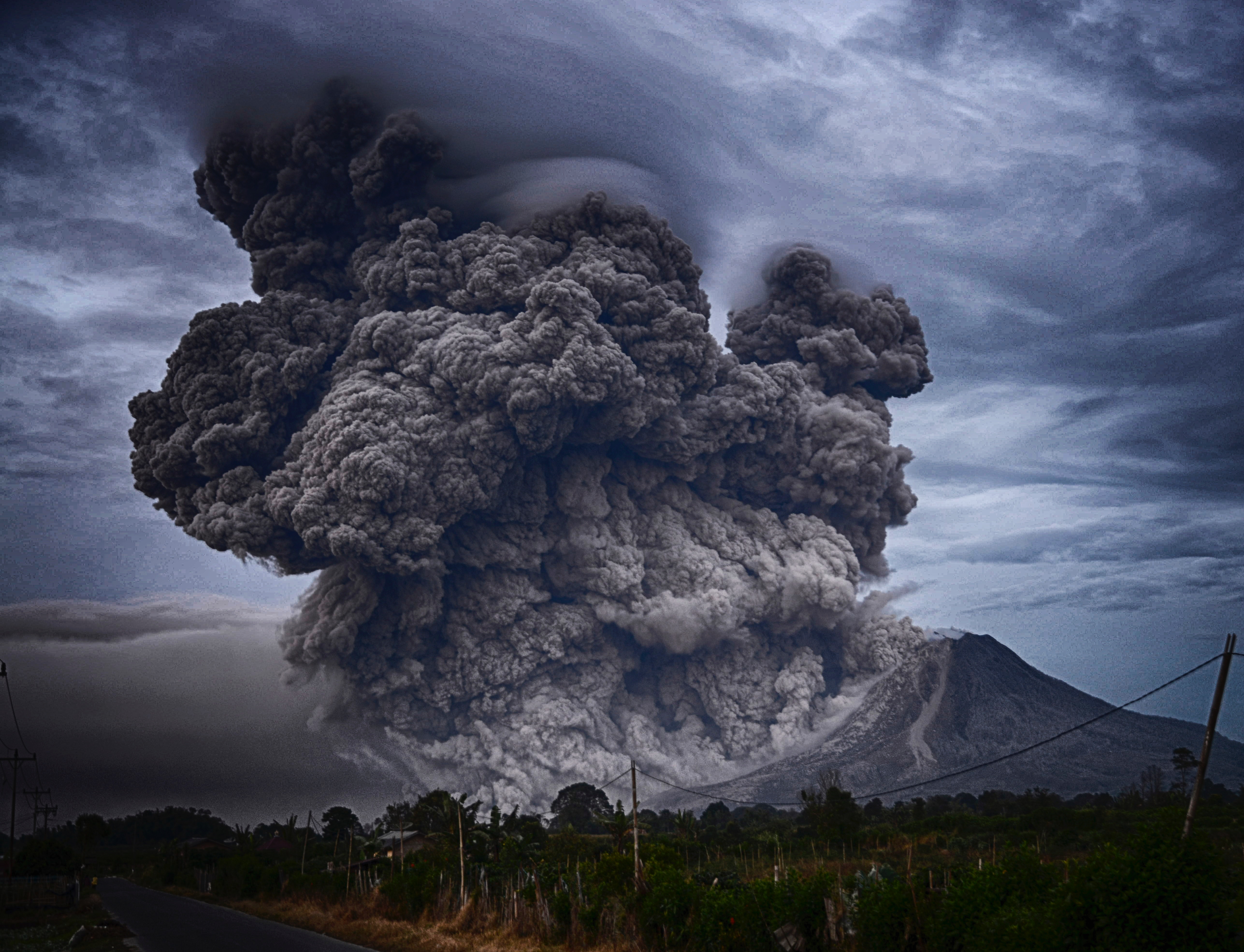 Erupting volcano with huge smoke plume
