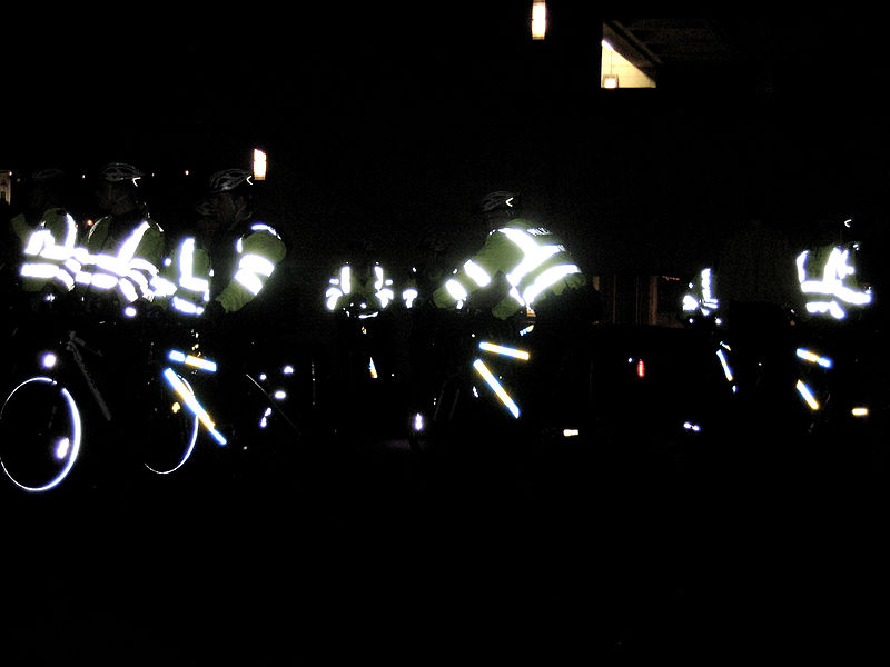 bikers with bright reflective strips at night