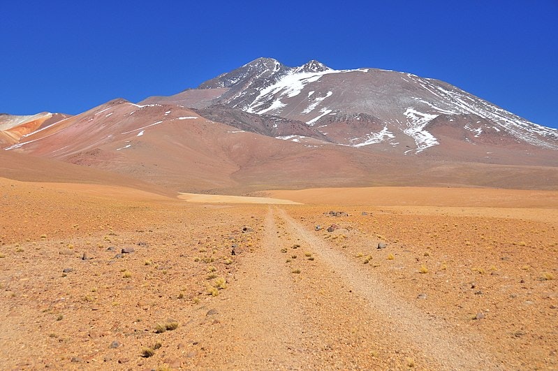 a volcano atop a desert landscape in Chile