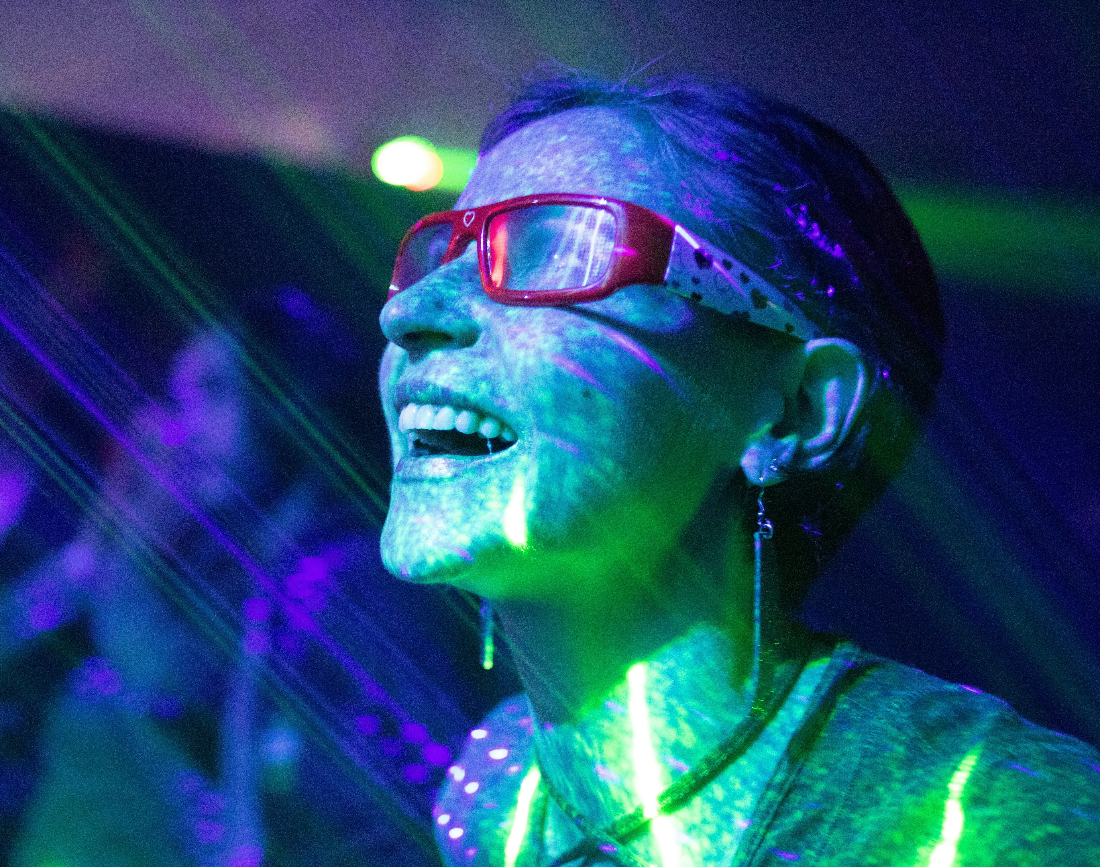a person wearing glasses with lots of colored lights shining on them