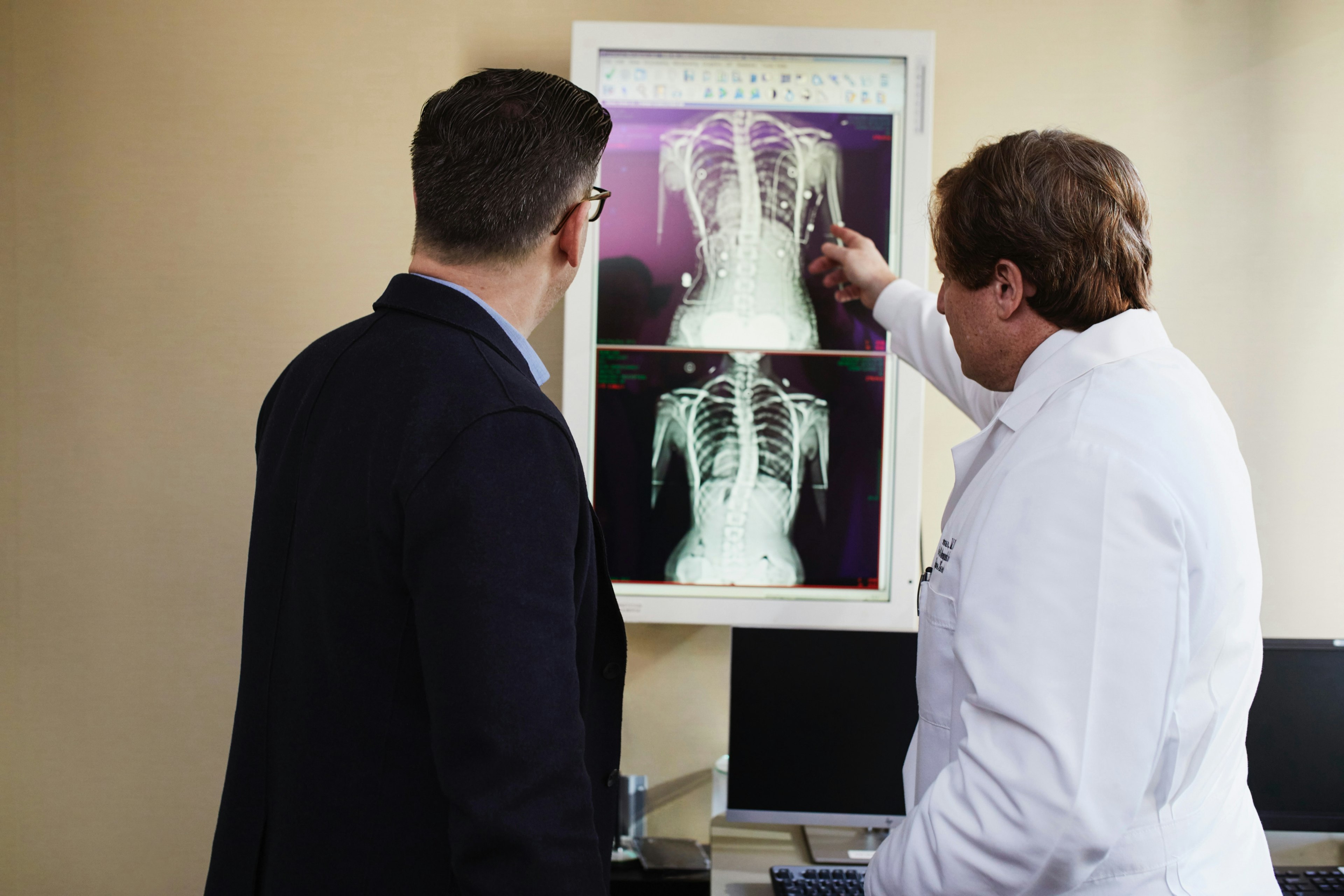 A doctor explains X-ray results to a patient.