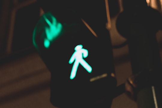 walk light at night illuminated green pedestrian walk light at night