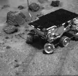 black and white gif of a small robot climbing a rock