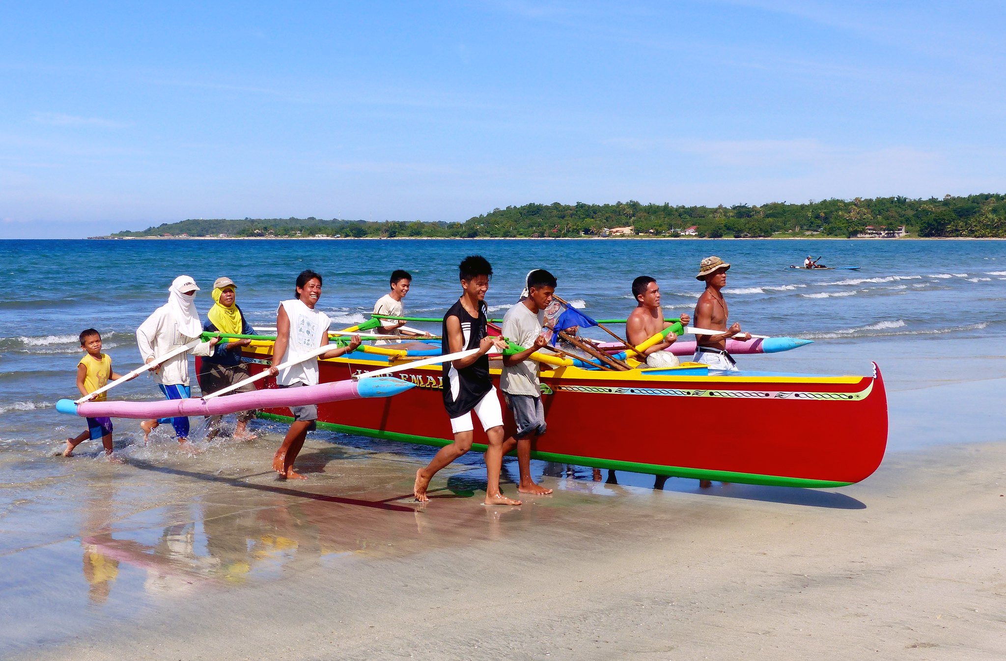 Fishers in Currimao Beach,
Ilocos Norte, Philippines, hauling their boat ashore