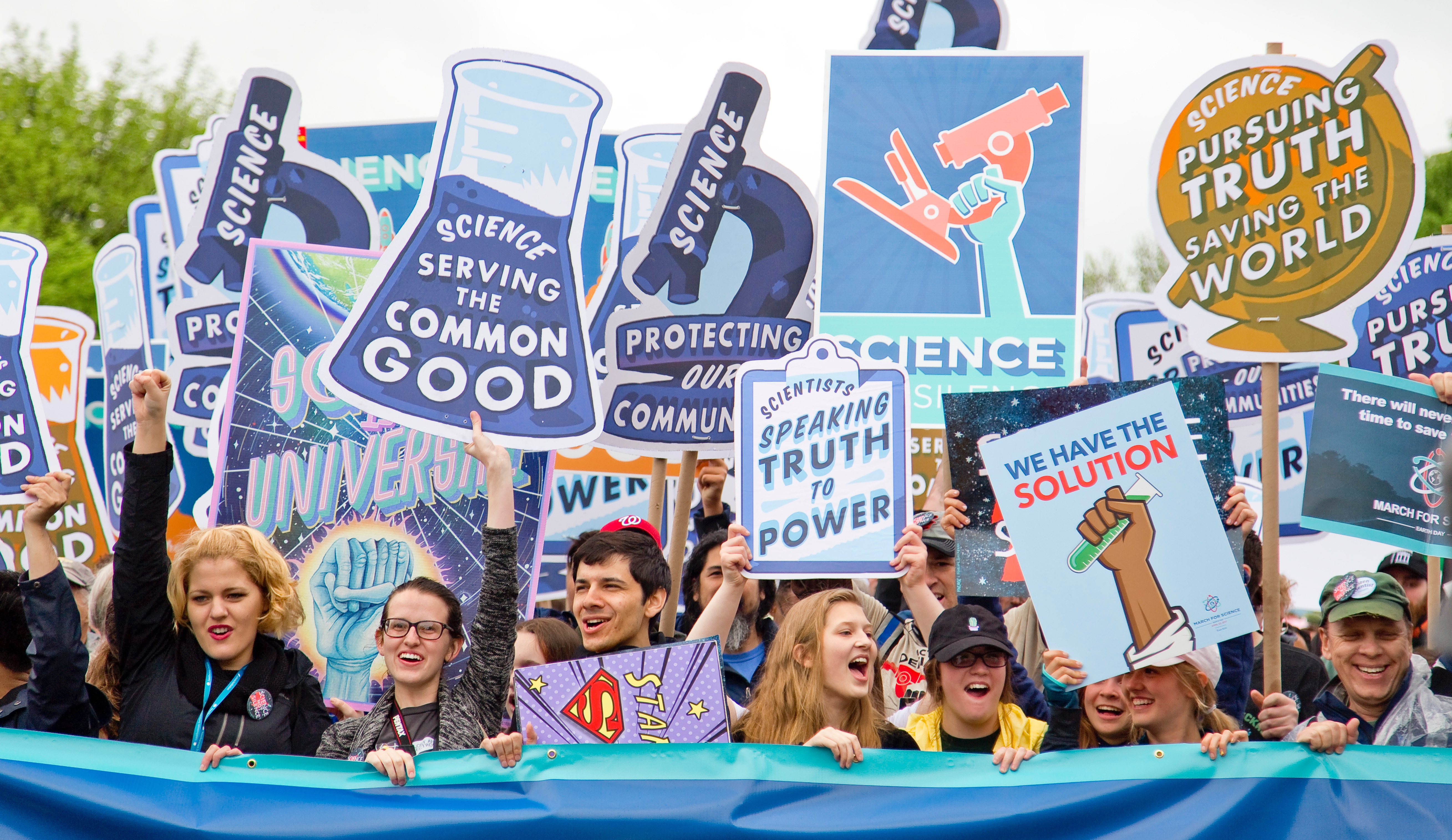 Protesters holding signs in support of science.