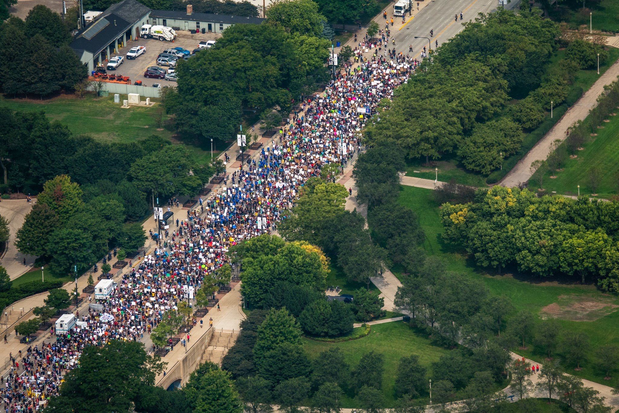 An aerial shot of a crowd of climate strikers marching down the street in Chicago, IL, USA.