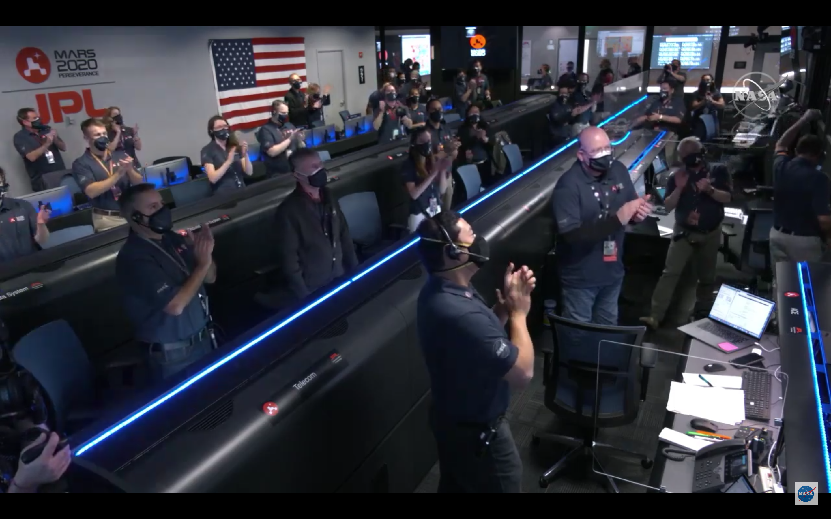 The NASA JPL crew applauding the successful landing