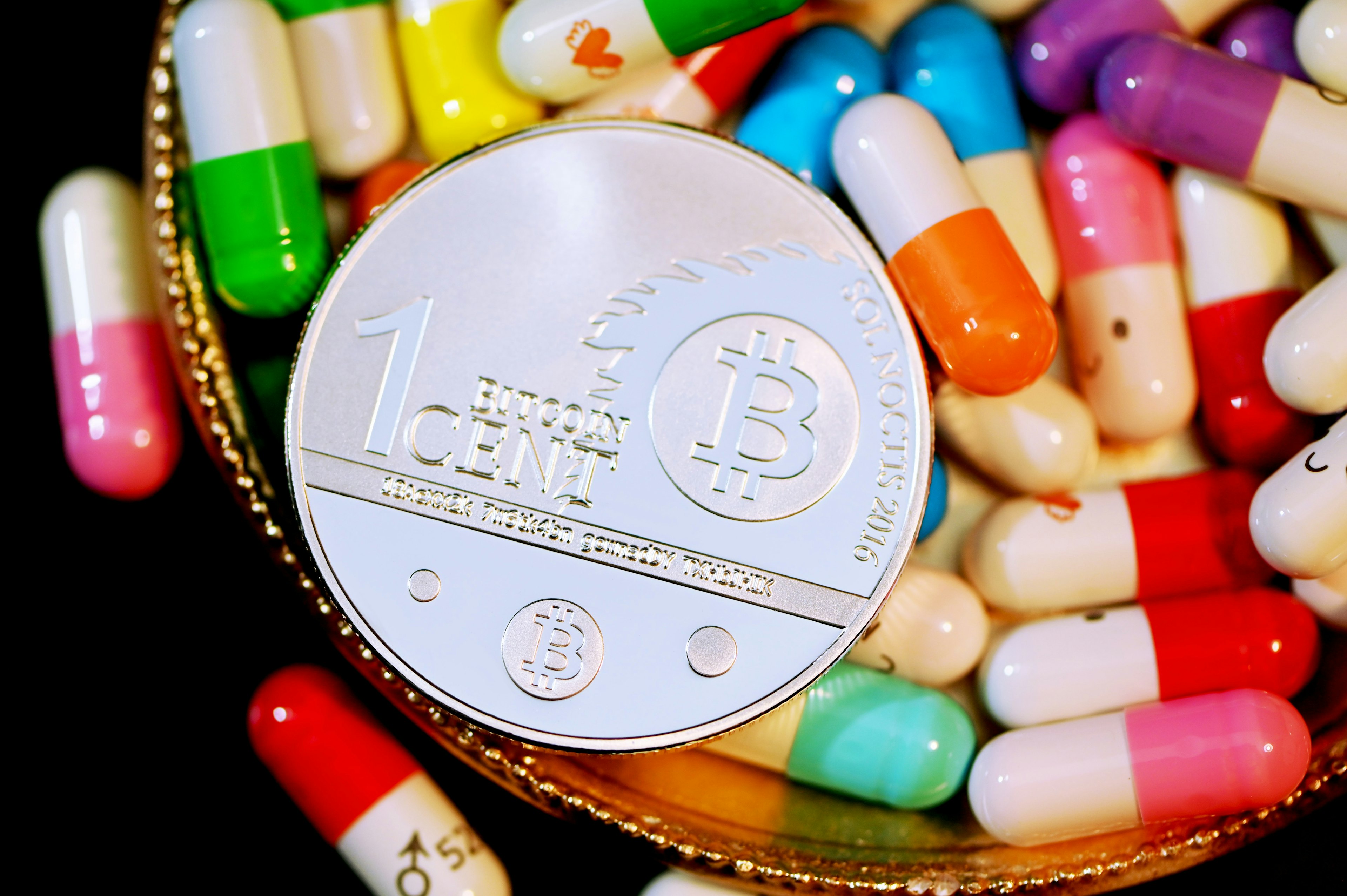 A Bitcoin on top of some pills