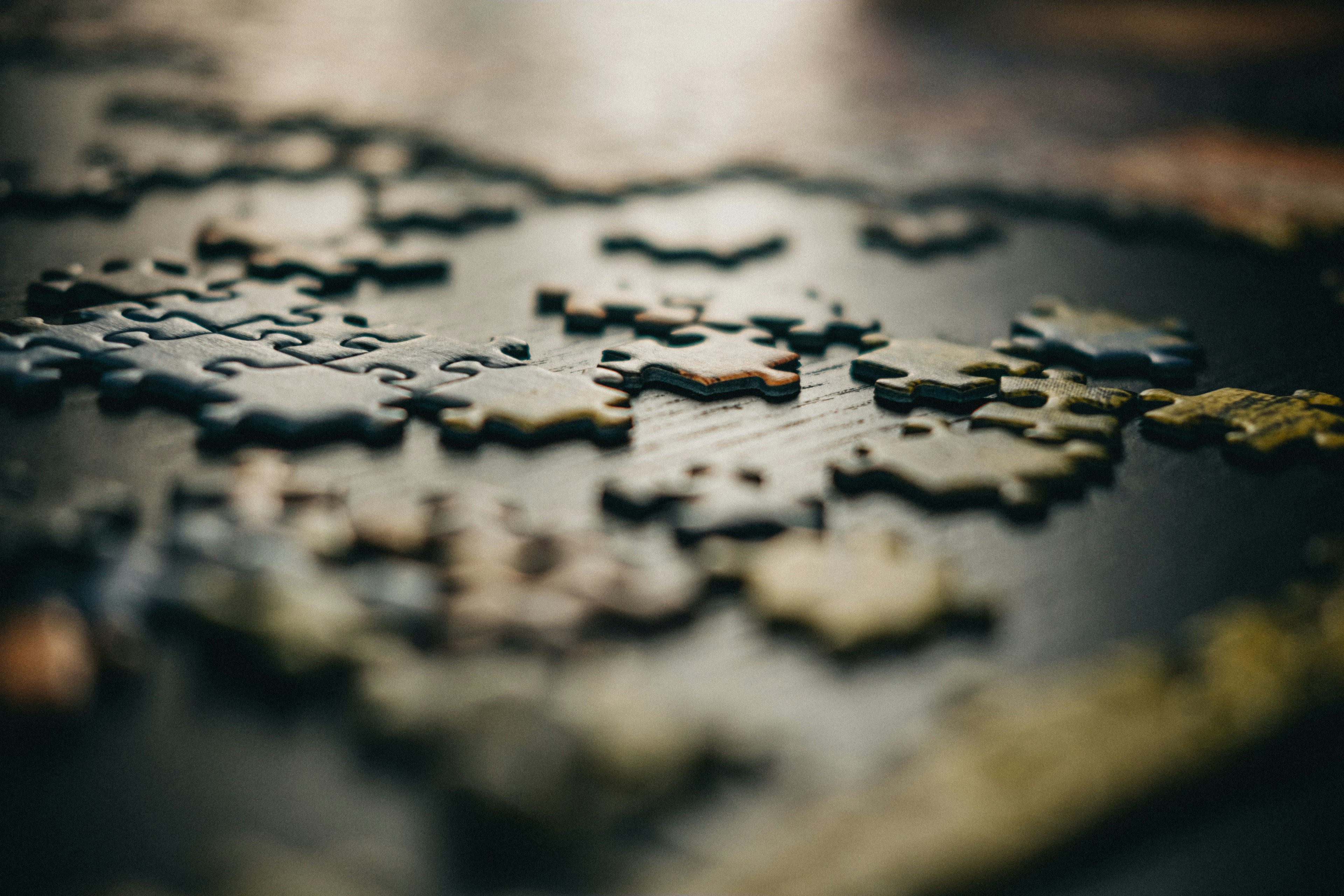 A close-up photo of mixed jigsaw puzzle pieces.
