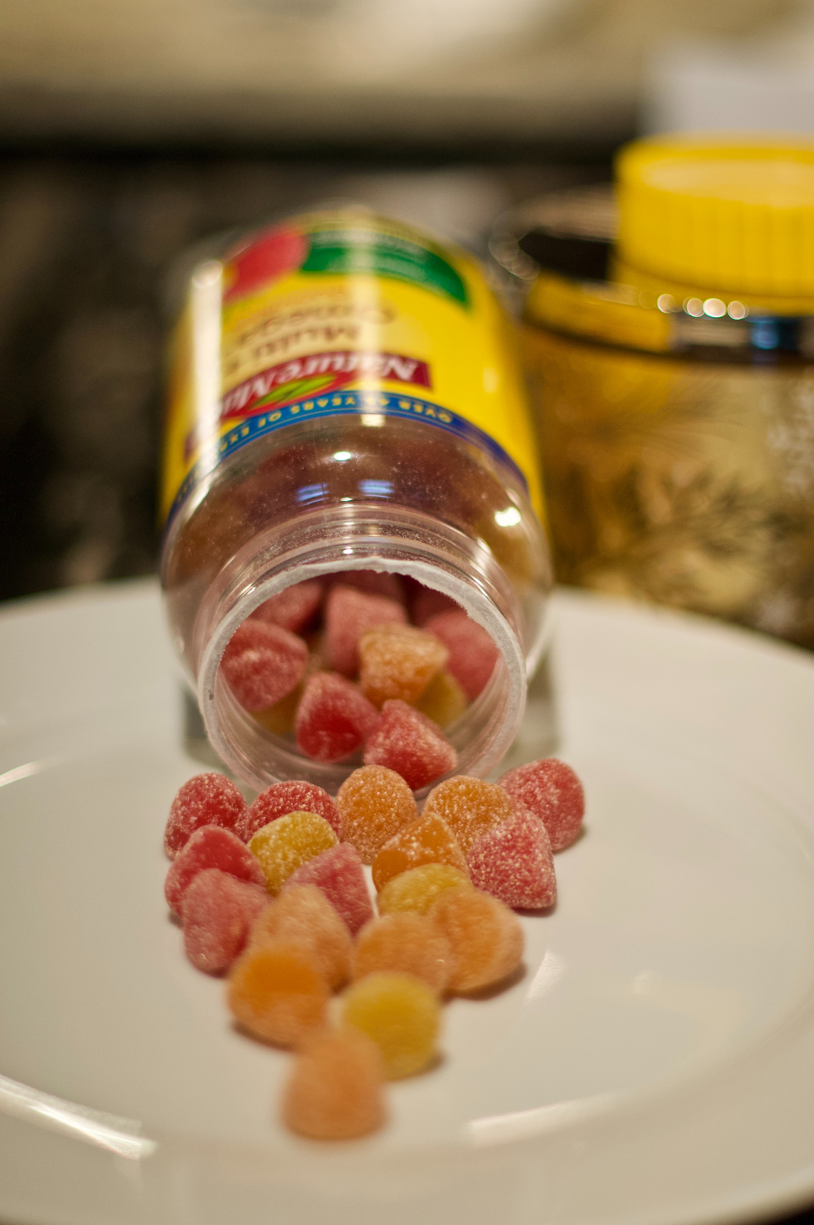 gummy vitamins spilling out of a bottle 