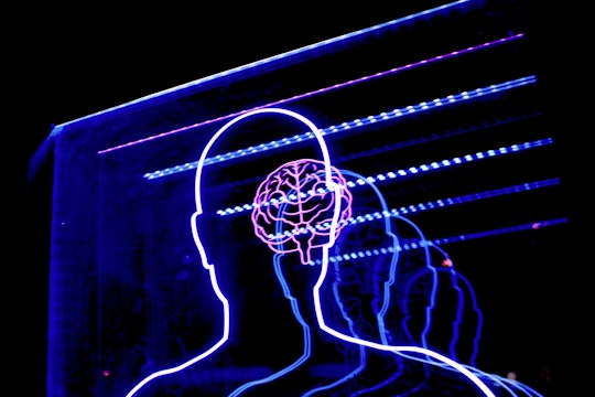 A neon sign in the shape of a person with a brain