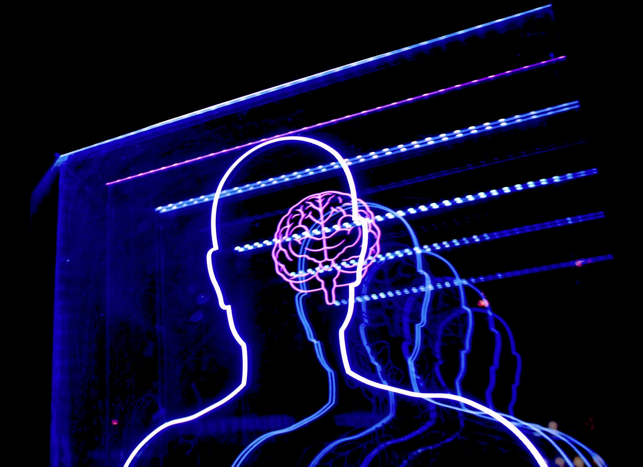 A neon sign in the shape of a person with a brain