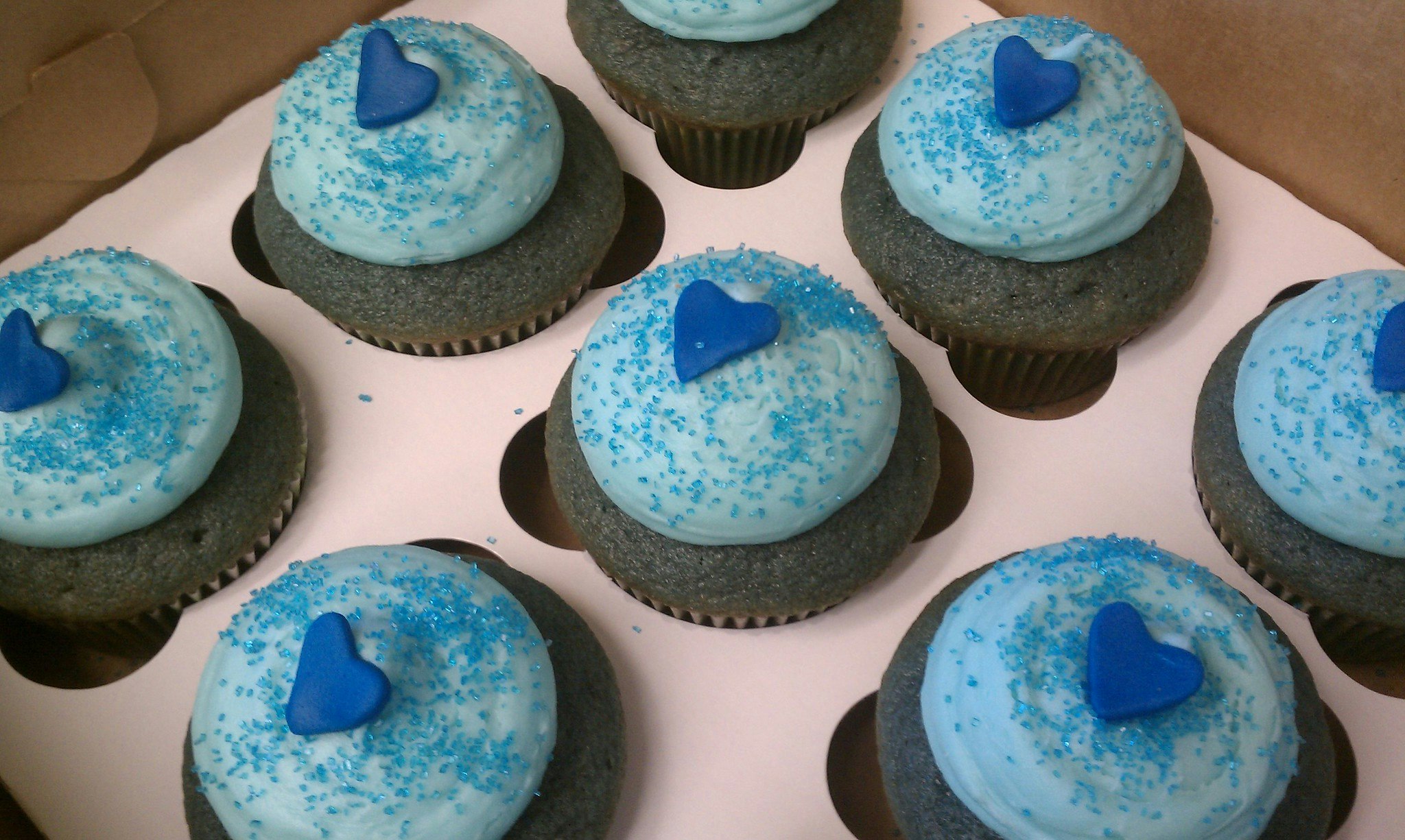 blue cupcakes with blue frosting and heart decoration