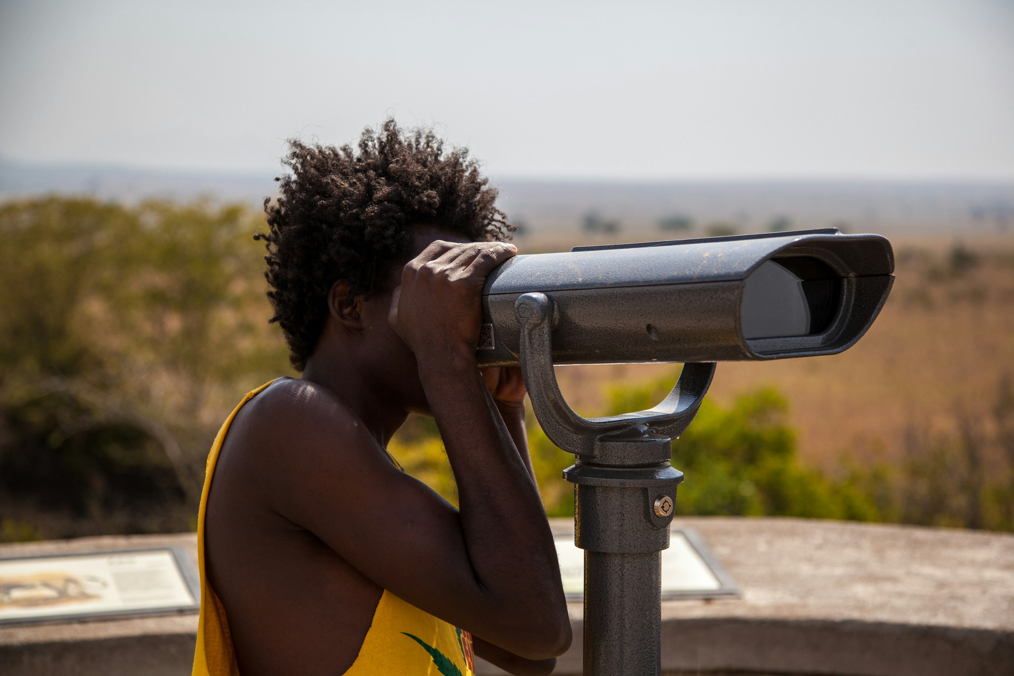 a woman looking through a telescope