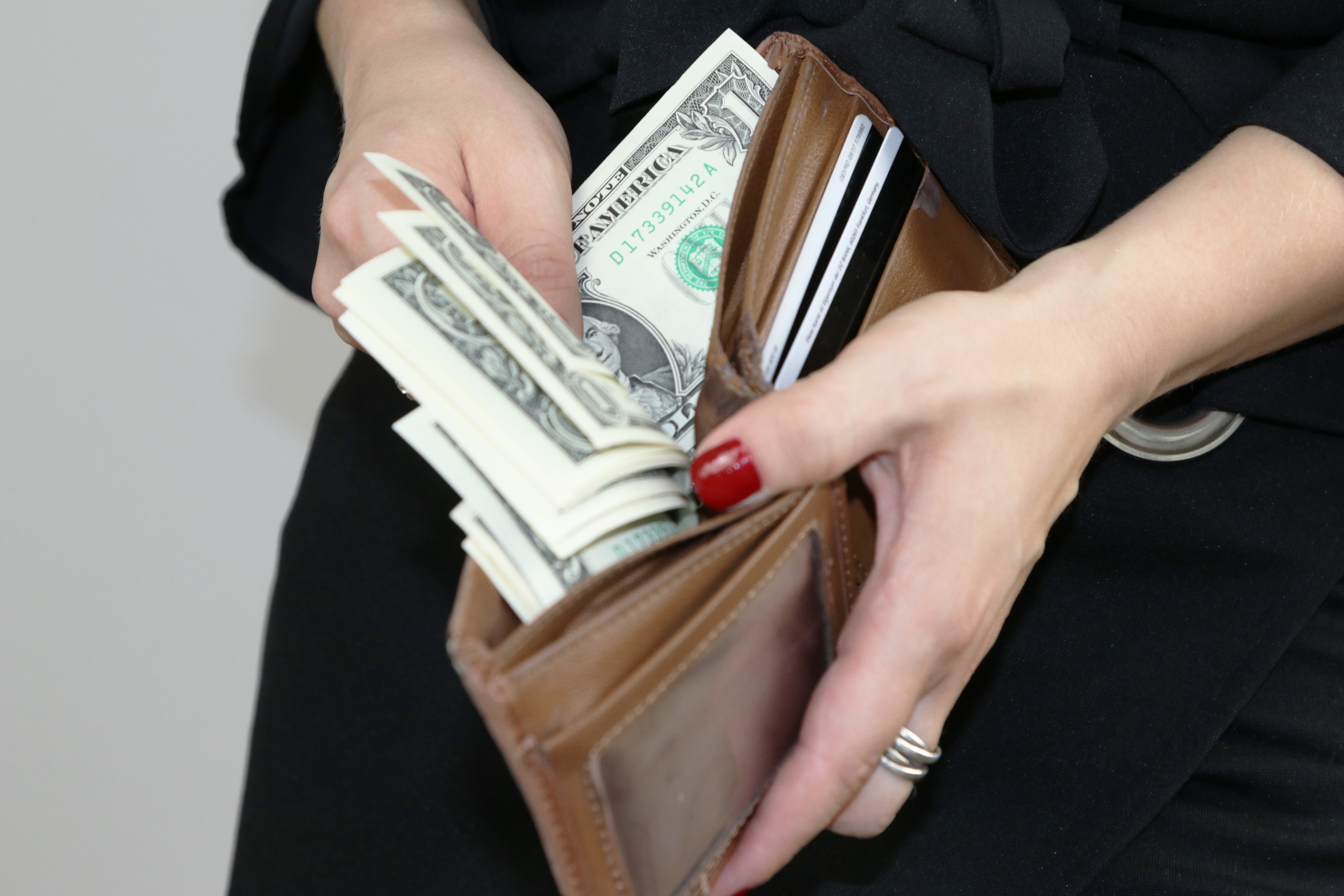 woman putting money in a wallet