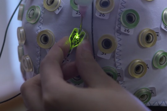 A patient is fitted with a cap covered in electrodes