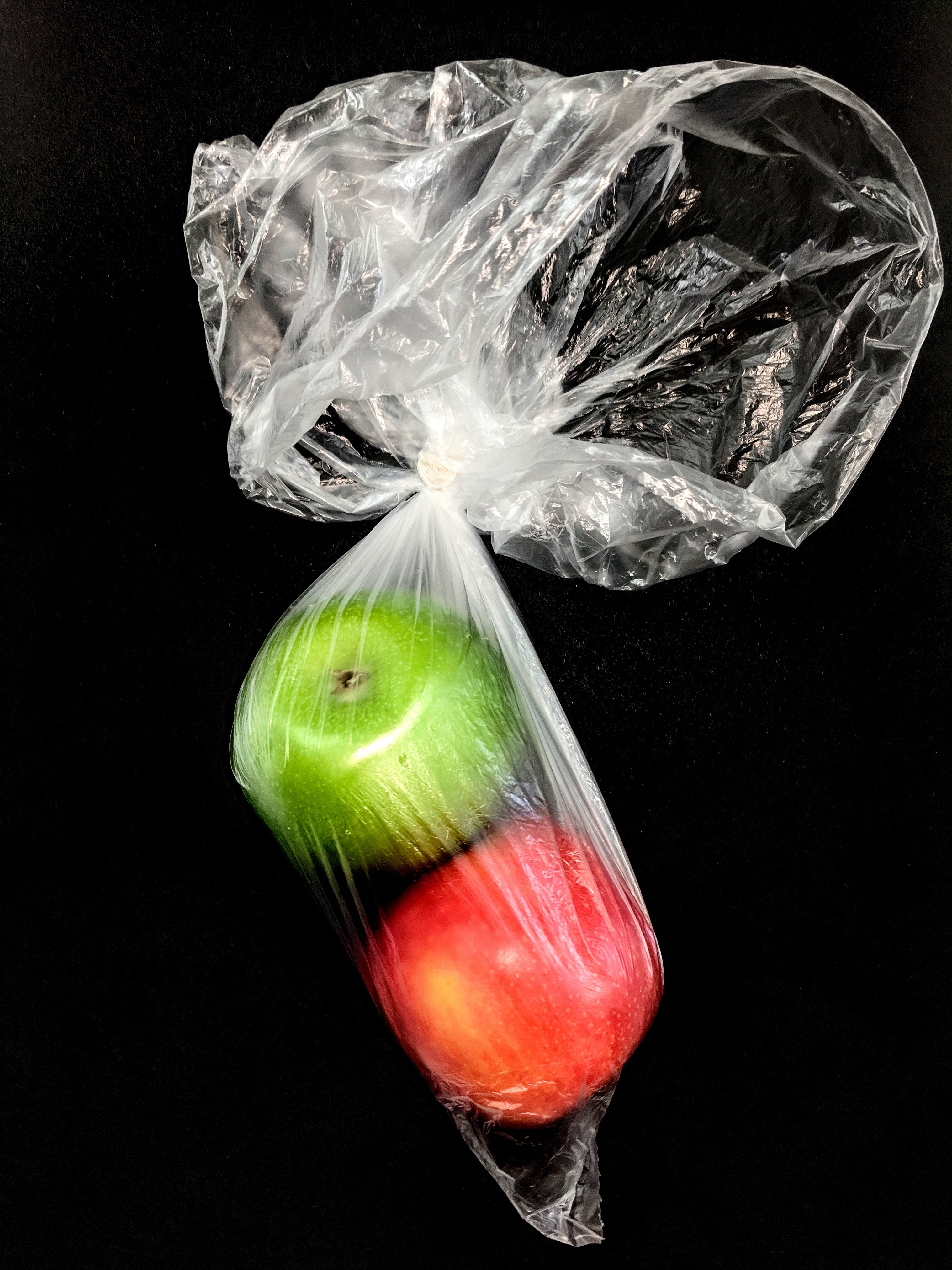 Two apples in a clear plastic bag
