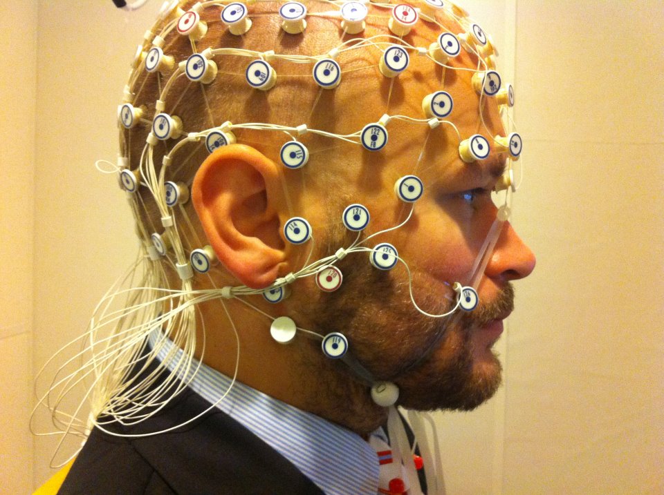 A man with EEG wires attached to his head.