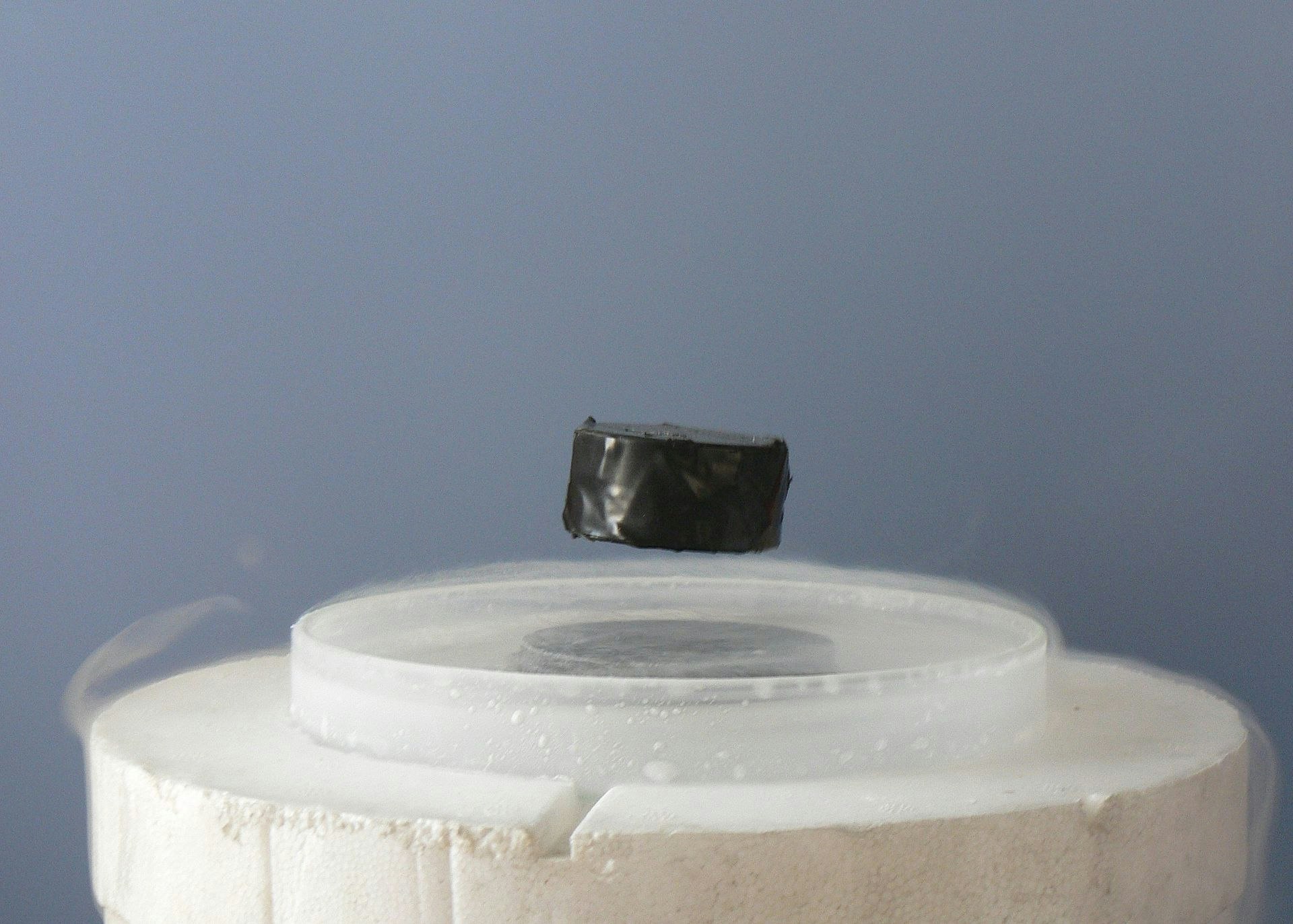 A magnet levitating above a high-temperature superconductor, cooled with liquid nitrogen. 